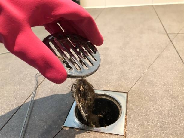 Clearing the shower drain clogged due to hair strands