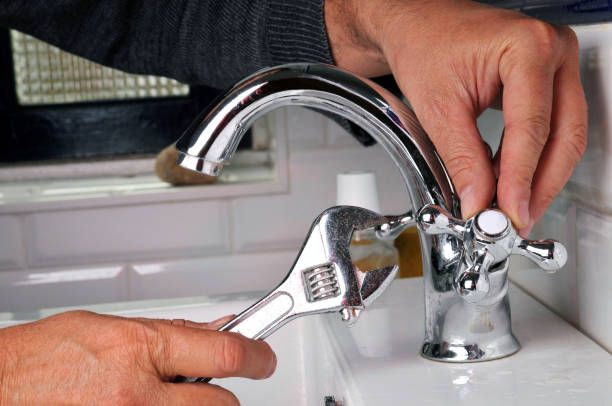 Plumber repairing a faucet