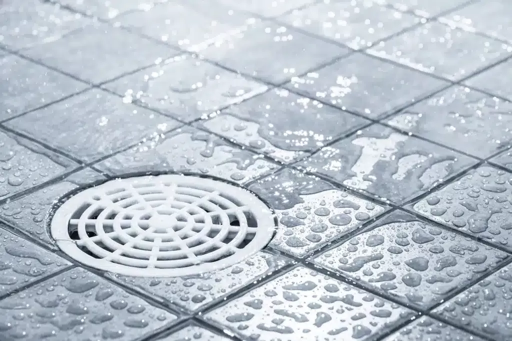 shower drain with droplets of water around